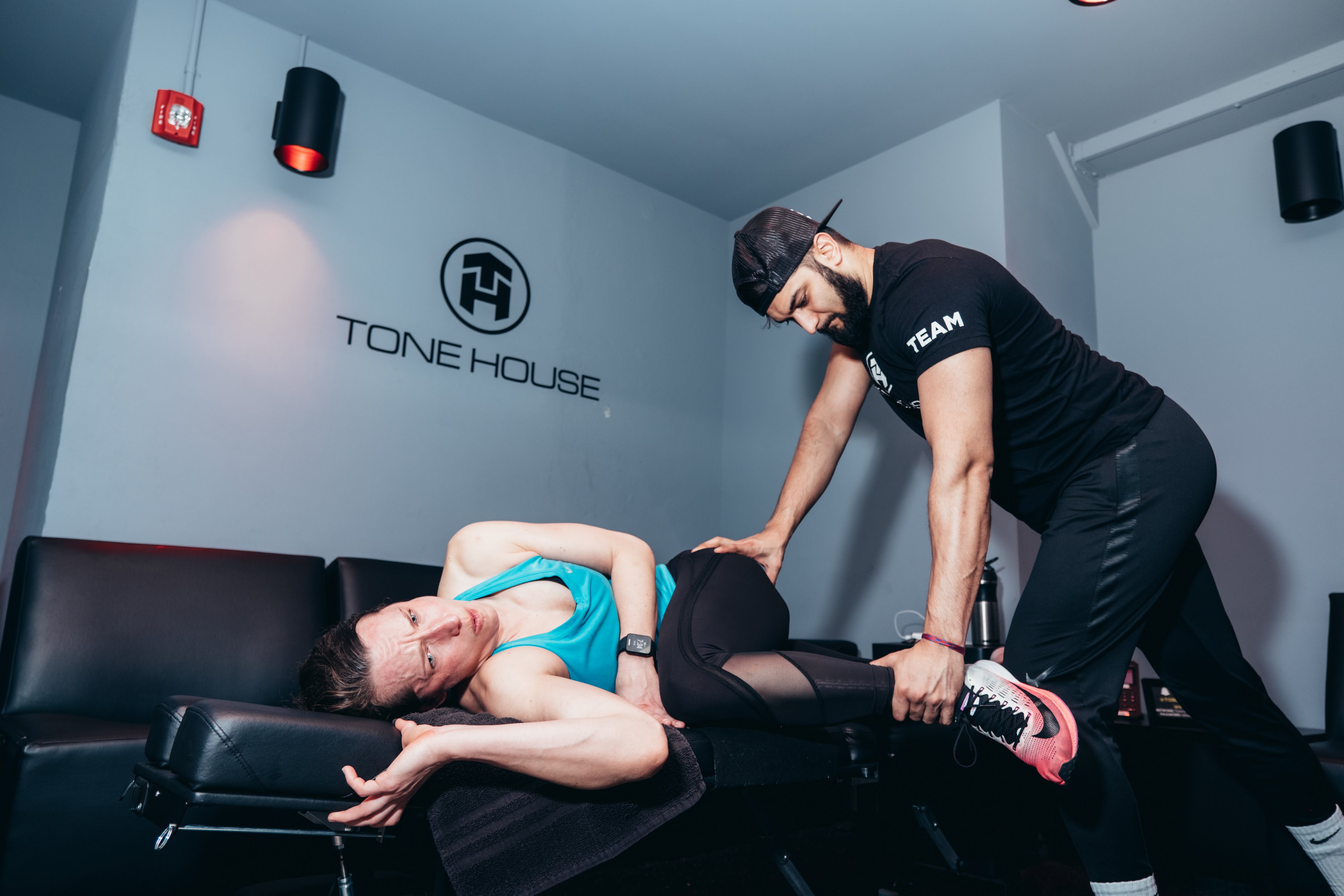 Dr. Kamraan helping a client with recovery