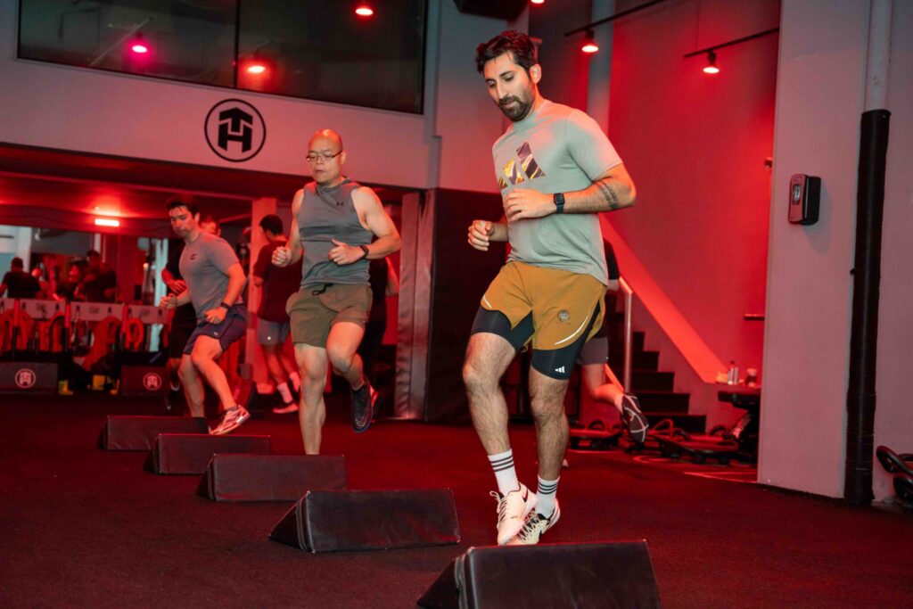 Athletes doing a lateral movement over Tone House bags.
